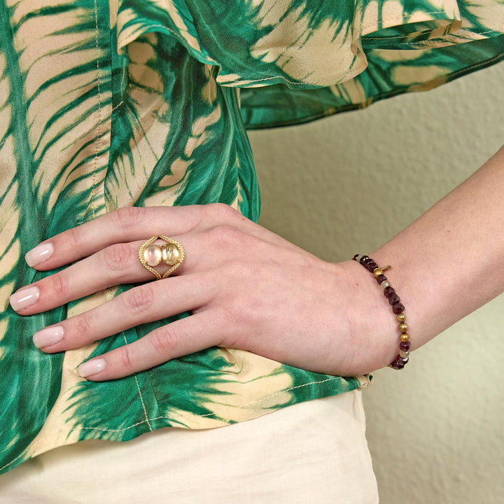 carre-simone-armband-met-granaat-gouden-kraal-en-labradoriet gezien bij de hand, granaatrode en gouden kralen. Modelfb4658gabglb