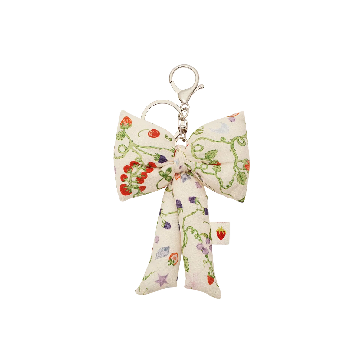 De Maanesten stoffen striksleutelhanger Garden Magic Ivory heeft een grote stoffen strik met bloemenprint en een zilverkleurige sleutelhaak. Model 4111
