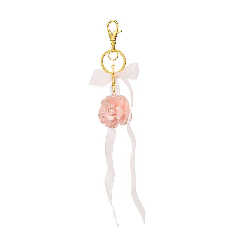 Moonstone Tenesa Keychain Blush heeft een roze bloemensleutelhanger met pareldetails, lint en gouden hanger. Model 3990 - één maat