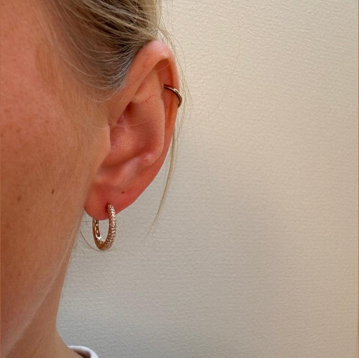 Mads Z La Boheme 8kt gouden Creolen Zirkonia weergegeven in het oor, elegante gouden kleur en fonkelende stenen. Model3317031-2