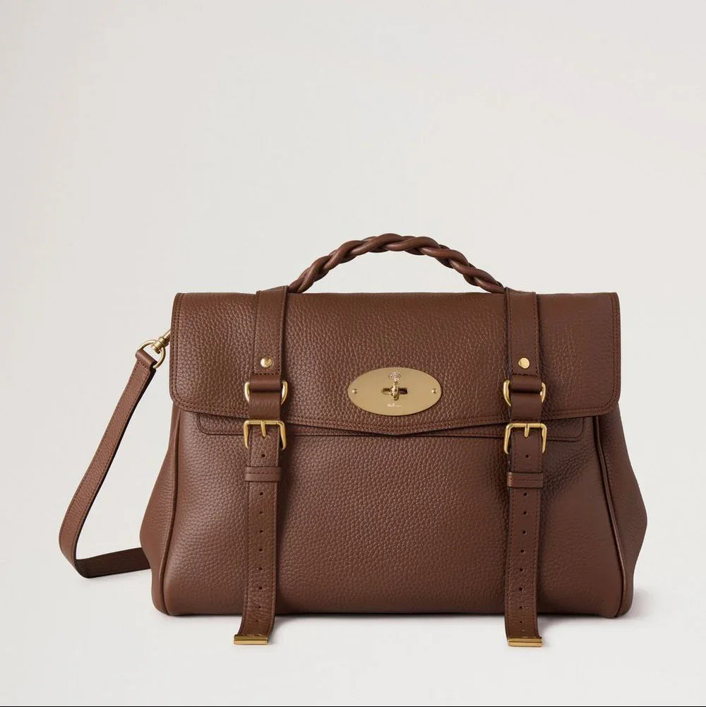 Mulberry Oversized Alexa Bright Oak Heavy Grain toont een grote bruine leren tas met gevlochten handvat en goudkleurige gesp. ModelHH6884/736G222