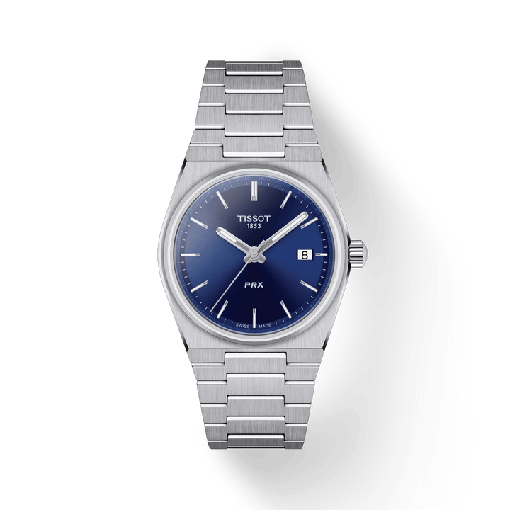 Tissot PRX met blauwe wijzerplaat, 35 mm, afgebeeld met zilverstalen ketting. ModelT1372101104100.