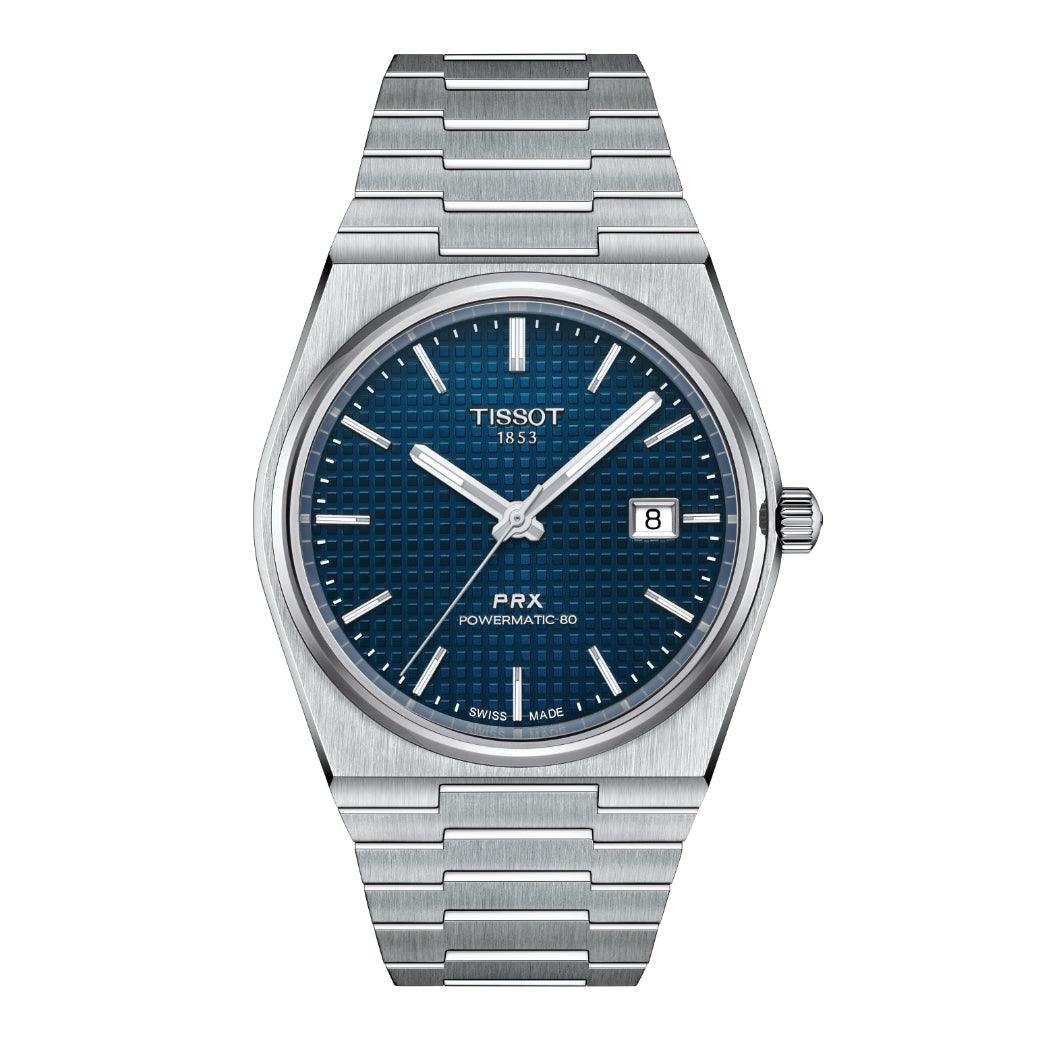 Tissot PRX Powermatic 80 met blauwe wijzerplaat, detail van stalen kast en ketting. ModelT1374071104100.